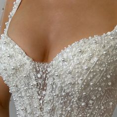 the back of a wedding dress with beading on it