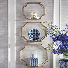 three shelves with blue and white vases on them