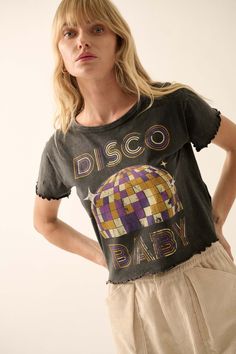 Mineral washed graphic t-shirt. Vintage-style disco ball graphic print with "Disco Baby" text print in retro disco font. Lettuce-edge detailing at hem and cuffs. Round neckline. Short sleeves. Cropped length. Relaxed fit. 100% Cotton. Imported top designed and printed in LA. Model wears size S. Retro Letter Print Tops For Festival, Retro Acid Wash Top For Concerts, Vintage Letter Print Tops For Party, Vintage Party Tops With Letter Print, Grunge Crew Neck Party Top, Grunge Crew Neck Top For Party, Retro Party Tops With Graphic Print, Retro Cotton Party Tops, Retro Graphic Print Tops For Party