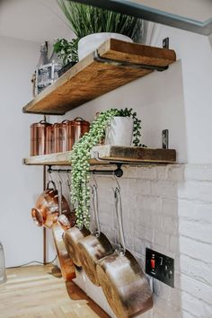 a shelf with potted plants and pots on it