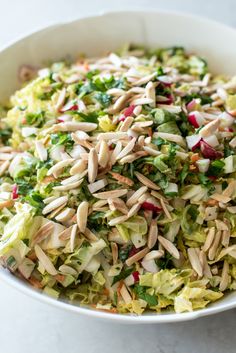 a white bowl filled with salad on top of a table