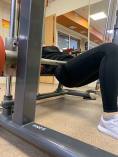 a woman doing squats on a bench in a gym