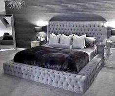 a large bed sitting in the middle of a bedroom