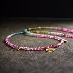 I adopt a unique approach that sets it apart. Unlike the conventional methods, I take special care to rearrange each tiny bead deliberately. This meticulous process achieves a subtle gradient of colors, ensuring a seamless transition between various shades of tourmaline. The result is a necklace of exceptional beauty and harmony. Investing extra time and effort into this careful arrangement allows me to fashion a distinctive and personalized piece, showcasing the complete spectrum of colors inherent in tourmaline. Tourmaline 2.5mm 14K Solid gold 15 inches / 38.1cm 【!!】 While the color of the necklace you receive may vary slightly, I'm committed to ensuring it maintains the same artistic beauty as depicted in the listing photos. 【Please Handle with Care】 A lot of my jewelry showcases dainty Bohemian Tourmaline Jewelry With Natural Stones, Bohemian Tourmaline Round Beads Jewelry, Handmade Tourmaline Bohemian Jewelry, Bohemian Tourmaline Bead Jewelry, Bohemian Tourmaline Round Bead Necklaces, Bohemian Tourmaline Bead Necklaces, Pink Tourmaline Bohemian Jewelry, Handmade Bohemian Tourmaline Necklace, Gold Schmuck