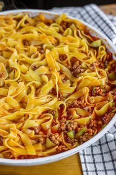 a casserole dish filled with pasta and ground beef is ready to be eaten