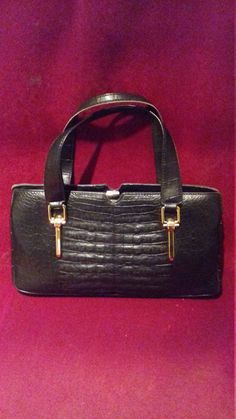 Here is a Great Vintage ladies black Moc Croc Handbag, This Great bag has 2 handles  and gold metal details on the front and good gold colour clasp it is fully lined with 2 inside pockets one has zip which is working. Also 2 slip pockets in bag.This vintage bag is good for any Great Rockin event day or night.  A great Vintage Piece for ALL you Great Vintage Lovers.  Label :  Rieke Model  Measurements:  approximately  Height :  7 - Inches  Length :  12 -3  Inches  Condition : Good Vintage Condition  Gold metal trim slightly tarnished in places. This is a vintage piece which has previously been used before and please check all pictures carefully as they make up part of the description, thank you  We ship worldwide PLEASE request a shipping quote for All purchases outside of the UK.    THANK Gold Satchel With Hasp Closure For Formal Occasions, Formal Gold Satchel With Hasp Closure, Gold Bags With Hasp Closure For Formal Events, Gold Bags With Hasp Closure For Formal Occasions, Formal Gold Bag With Hasp Closure, Formal Handheld Shoulder Bag With Crocodile Pattern, Formal Handheld Crocodile Pattern Shoulder Bag, Evening Satchel With Crocodile Pattern, Rectangular Shape, Rectangular Evening Satchel With Crocodile Pattern