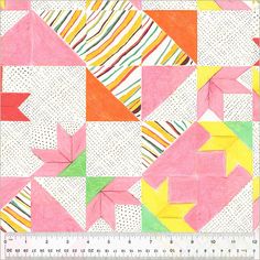 a ruler is next to a colorful quilt