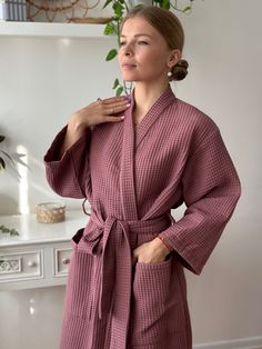 "Wrap yourself in luxurious comfort with our handcrafted Waffle Kimono Style Bathrobe. Experience the embrace of the softest waffle texture, ensuring a cozy, high-quality, and sustainable indulgence. Ideal for gifting on any occasion. This robe invites you to revel in the spa experience within your own home. Crafted from 100% pure organic Netherlandish cotton and certified by Oeko-Tex Standard 100, this robe guarantees premium quality and environmental consciousness. Revel in its absorbency, quick-drying nature, and breathability, while relishing its durable and hypoallergenic properties. Our commitment to comfort and sustainability extends to the 100% cotton waffle material, ensuring easy garment care for lasting enjoyment. Key Features: Unparalleled softness and comfort Quick absorption Home Robe Women, Waffle Robe Women, Pink Spring Kimono For Home, Pink Kimono For Home Use In Spring, Pink Kimono For Home During Spring, Pink Cotton Sleep Robe, Pink Spring Robe For Relaxation, Pink Robe For Spring Relaxation, Feminine Long Sleeve Kimono For Loungewear