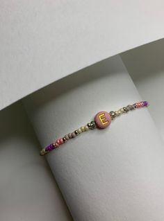 This cute coloristic bracelet is made in pinky shades, out of 2mm seed beads and 6 mm acrylic letter bead which can be personalised :)  The design of the lock makes it stand out and gives an interesting look to this minimalist bracelet.  Inspired by traditional Uzbek fabric pattern. ADJUSTABLE Length: 16.5 cm - 22.5 cm All iteams are uniquely design and made by me.  DISPATCHING AND DELIVERY  - It would require up to three working days for items to be made and dispatched. Shipping with a Tracking Embroidery Bracelet Initials, Minimalist Handmade Name Bracelet For Everyday, Trendy Everyday Name Bracelet With Letter Beads, Personalized Pink Dainty Beaded Bracelets, Everyday Pink Beaded Name Bracelet, Dainty Friendship Beaded Bracelets With Letter Beads, Everyday Pink Beaded Bracelets With Letter Beads, Dainty Pink Beaded Bracelets With Letter Beads, Dainty Pink Beaded Bracelet With Letter Beads