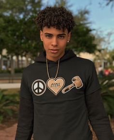 a young man wearing a peace sign hoodie with hammer and sick heart on it