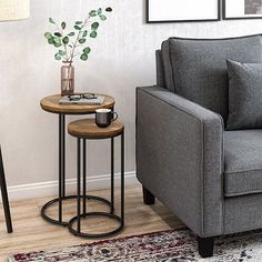 a living room with a gray couch and two side tables on top of each other