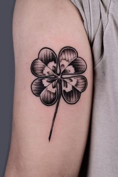 a four leaf clover tattoo on the arm