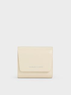 This product is made with at least 20% sustainable materials by weight. CHARLES & KEITH uses recycled, degradable, organic, and water-based materials in our eco-conscious collection.There is more than meets the eyes with this Irie small wallet. Sporting a bright beige finish, this piece may be small and compact, but it opens up to a well-compartmentalised interior that has sectioned parts for cards, cash and more. This functional and versatile wallet also comes with a detachable card holder that Wallet Gifts, Charles Keith, Small Wallet, Eco Conscious, Sustainable Materials, Sales Gifts, Card Wallet, Trending Shoes, Card Holder