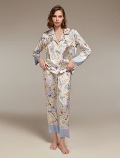 Discover the epitome of luxury sleepwear with our Silky Satin Pyjama Set. Enveloped in a charming floral print, this lush satin set strikes the perfect balance between opulent style and plush comfort. Its exotic printed panel accents on the sleeves and trouser hem introduce an untamed twist to your nighttime routine. The elegant button-up notch collar and long-sleeve top impart a timeless allure, ideal for both relaxation and slumber. The beautifully pleated trousers, featuring a soft elastic semi waistband at the back, assure an optimum fit for serene nights. The breathable material with a subtle glossy finish makes this set an outstanding choice for pyjama soirees, casual days in, or luxurious bridal sleepwear. This unique set can become a treasured part of your wardrobe or a lavish gift Expensive Sleepwear, Silky Pjs, Elegant Pajamas, Elegant Sleepwear, Designer Pajamas, Bridal Sleepwear, Loungewear Summer, Satin Pyjama, Stylish Pajamas