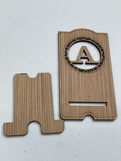 two wooden coasters with the letter a on one and an initial on the other