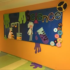 a classroom wall decorated with colorful art and decorations