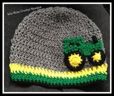 a crocheted hat with a green and yellow tractor on it