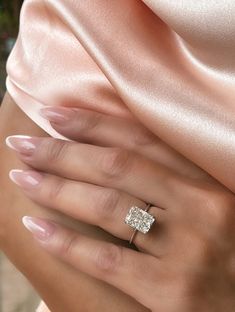 a woman's hand with a diamond ring on it