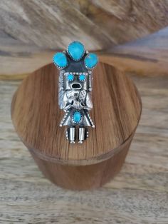 Large Kachina ring in sterling silver and turquoise stones is truly unique! This statement ring is carefully handmade with intricate sterling silver detail work and including concho pieces on the sides and is set off with a lovely turquoise stones. If you love Navajo jewelry, you will love this sterling silver ring. This ring is quite long measuring 2 inches long and sits beautifully on the hand. This statement ring is sure to get you noticed! It would make a lovely anniversary gift or birthday Artisan Multi-stone Ring Jewelry, Artisan Multi-stone Ring, Artisan Turquoise Collectible Rings, Handmade Bohemian Turquoise Ring In Sterling Silver, Handmade Bohemian Turquoise Sterling Silver Ring, Unique Turquoise Jewelry With Stone Setting, Southwestern Gemstone Rings For Collectors, Unique Turquoise Multi-stone Rings, Handmade Turquoise Toe Rings