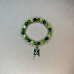 Super cute green beaded bracelet with a frog charm Cheap Green Novelty Bracelets, Green Hand-strung Bracelets For Friendship, Green Bracelets For Friendship, Casual Green Beaded Bracelets With 8mm Beads, Green Hand-strung Jewelry For Friendship, Casual Green Beaded Charm Bracelet, Casual Green Hand-strung Beaded Bracelets, Casual Green Beaded Bracelets, Casual Green Jade Jewelry