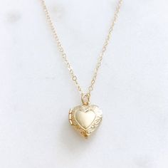 DESCRIPTION: The CHARLOTTE Necklace - Gold Heart Locket on a dainty gold filled chain. We love this sweet little necklace and think you will too! Insert a treasured photo and keep it close to your heart! The cutest way to show your love for someone special!MATERIALS:Chain, Clasp, Jump Rings - Gold Filled  Locket - Gold PlatedPENDANT SIZE:Approximately 1/2” in lengthPACKAGING:Your necklace will arrive on a Dainty Doe signature jewelry card placed in a white jewelry box, with a bow and tag, perfec Dainty Open Heart Locket Necklace, Dainty Open Heart Locket Necklace For Keepsake, Dainty Locket Necklace For Valentine's Day Keepsake, Delicate Locket Necklace For Valentine's Day, Dainty Heart Pendant Locket Necklace For Keepsake, Elegant Heart Necklace With Vintage Charm As Gift, Delicate Heart Pendant Locket Necklace, Dainty Open Heart Locket Necklace With Heart Charm, Heart-shaped Gold Jewelry With Vintage Charm