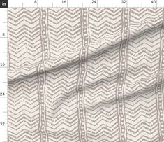 an image of a white and grey fabric with wavy lines on the side, as well as a ruler