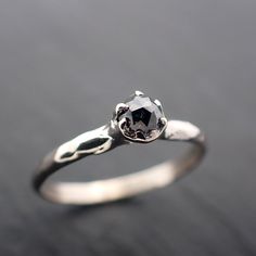 a white gold engagement ring with a black diamond