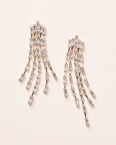 It's all in the name of our Cascade Statement Earrings. Designed with linked CZ baguettes that dangle in the perfect cascading statement earring. Lightweight for long wear. Dangle earrings are available in silver and gold. Glamorous Festive Dangle Bridal Earrings, Glamorous Silver Long Drop Earrings, Luxury Statement Diamond Dangle Earrings, Statement Bridal Earrings Dareth Colburn, Cascading Earrings, Evening Jewelry: Rhinestone Fringe Drop Earrings, Wedding Earrings Gold, Gold Wedding Earrings, Baguette Earrings