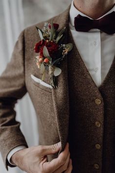 a man wearing a brown suit and bow tie