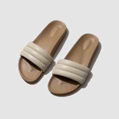 Inspired by the fantasy of a summer day, SHELL is a reminder of a simpler time foraging for seashells on the beach, and the sheer pleasure of the bounty collected by sunset. Featuring a dense, sculpted foam sole, our Sandalias are expertly crafted and sophisticatedly wrapped in soft, high quality lambskin.  While our S Cream Open Toe Slides For Beach, Beige Closed Toe Slides For Beach, Beige Closed-toe Slides For The Beach, Beige Closed Toe Slides For The Beach, Beige Slides With Textured Sole For Beach, Cream Slip-on Slides For The Beach, Beige Beach Slides With Rubber Sole, Cream Sandals With Rubber Sole For Beach, Seashells On The Beach