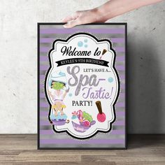 a hand holding up a sign for a spa party