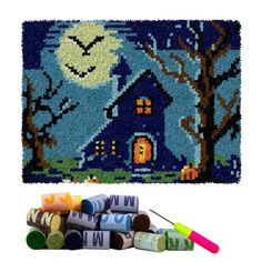 an assortment of crayons and paint tubes in front of a halloween scene