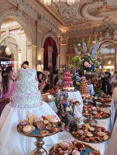 a table filled with lots of different types of cakes and pastries on top of it