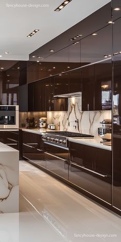 a modern kitchen with marble counter tops and dark wood cabinetry, along with stainless steel appliances