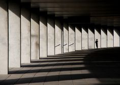 the shadow of a person standing in an empty parking garage