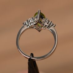 It is a natural peridot ring. The main stone is 6mm*12mm marquise cut, weight about 1.55 carats. The basic metal is sterling silver and plated with rhodium. To change the metal to a solid gold (white/rose) or platinum is also available, please ask for a quotation if you want. You can also go to my shop Home for more elegant rings: https://www.etsy.com/shop/godjewelry?ref=hdr_shop_menu More peridot rings: https://www.etsy.com/shop/godjewelry?section_id=20709252 Customization is always welcome and Peridot Rings, Elegant Rings, August Birthstone, Peridot Ring, Elegant Ring, August Birth Stone, Green Gemstones, Marquise Cut, Promise Ring