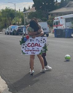 a woman holding a sign that says it's my goal to be so happy you