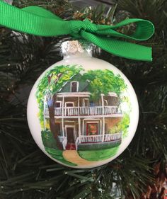 a christmas ornament with a house painted on it