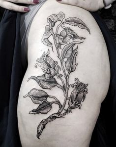 a woman's thigh with a flower tattoo on it