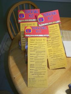 three yellow and red survival kits sitting on top of a wooden table