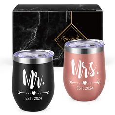 two personalized wine tumblers are shown in front of a black box and marble background