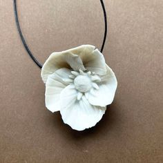 The Striped Anemone necklace is handmade . Every flower is handmade one by one in white porcelain clay, dryed and  fired in the very high temperature to ensure the clay is robust, assembled with a black cotton  thread. Please handle with attention due to the fine nature of porcelain.The flower is  3.5 / 4 cm diameter.The lenght is about 17.8 inch / 45 cm. I can customize lenght as you want. Adjustable White Nature-inspired Necklace, White Adjustable Nature-inspired Necklace, White Flower-shaped Nature-inspired Necklace, White Flower Necklace With Nature-inspired Style, White Ceramic Jewelry Gift, White Ceramic Jewelry For Gifts, White Ceramic Jewelry As A Gift, White Artisan Polymer Clay Jewelry, Handmade Clay Flower Jewelry