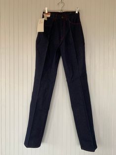 "Rare NWT Vintage Early 80s High Waisted Dark Denim Blue Jeans, by Hush Puppies. New condition and unworn with original tags. Super high rise waist. Front & back pleated down center of leg. Dark denim with red stitching, embroidered back pockets with basset hound logo. Amazing Original condition with original store tags! Brand - Hush Puppies Condition - Original. Deadstock from the 80s, New with original tags 100% Cotton Made in Taiwan Machine Washable Vintage Size - 8 Size - 26\" waist Best Retro Stretch Flare Jeans, Fitted High Rise Recycled Denim Bottoms, Fitted High-rise Recycled Denim Bottoms, Retro Stretch Cotton Jeans, Retro Fitted Denim Bottoms, Retro Fitted Medium Wash Jeans, Medium Wash Retro Fitted Jeans, Vintage Stretch Denim Blue Jeans, Fitted Medium Wash Rigid Denim Pants