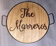 a wooden sign that says the mariners on it's side, sitting on top of a table