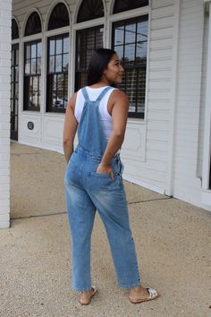 "Get ready to rock a cool, casual look with our Distressed Denim Overalls! The perfect mix of comfort and style, these overalls feature a loose fit and handy pocket for all your essentials. Say goodbye to boring outfits and hello to effortless cool. Denim never looked so good!" High Rise Denim Jumpsuit With Pockets In Utility Style, Casual Summer Overalls With Side Pockets, Relaxed Fit Overalls For A Day Out, Everyday Dark Wash Overalls With Pockets, Relaxed Fit Denim Jumpsuit Overall For Day Out, Casual Light Wash Overalls, Relaxed Fit Denim Jumpsuit For Day Out, Casual Denim Jumpsuits And Rompers With Side Pockets, Casual Relaxed Fit Shortalls For Day Out