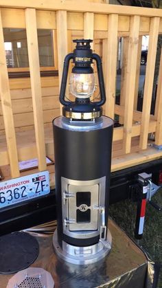 a lantern is sitting on top of a metal stand in the back of a truck