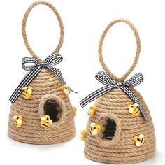 two birdhouses made out of rope with bees on them