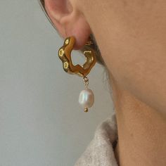 Indulge in luxury with Celine. With a modern twist on a classic design, these pearl earrings make an elegant statement and are sure to turn heads. Gold Plate 20mm Outer Diameter 1.5" Drop Waterproof & Tarnish Resistant Nickel- & Lead-Free Modern Pearl Chain Earrings, Modern Gold Earrings With Pearl Chain, Modern Single Pearl Earring In Metal, Modern Gold Earrings With Pearl Pendant, Modern Pearl Chain Earrings As Gift, Celine Pearl, Drop Gold Earrings, Pearl Drop Earrings Gold, Iron Mountain