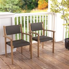 two chairs sitting on a deck next to each other