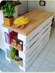 a kitchen island made out of pallets with bananas on top and other items around it